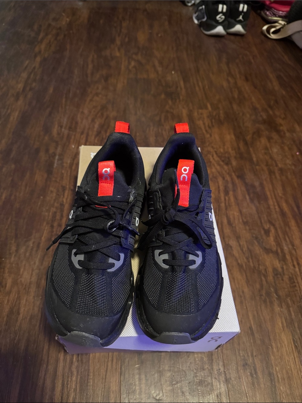On Running kid’s Black Athletic Shoes with Red Pull Tabs